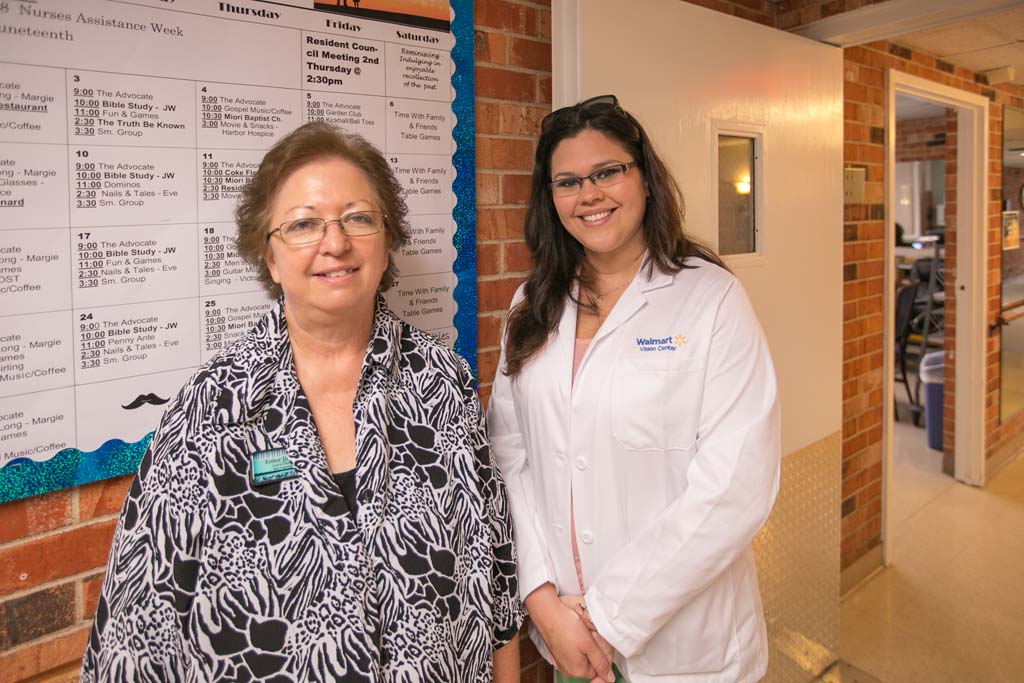 Staff member with a resident in a hallway
