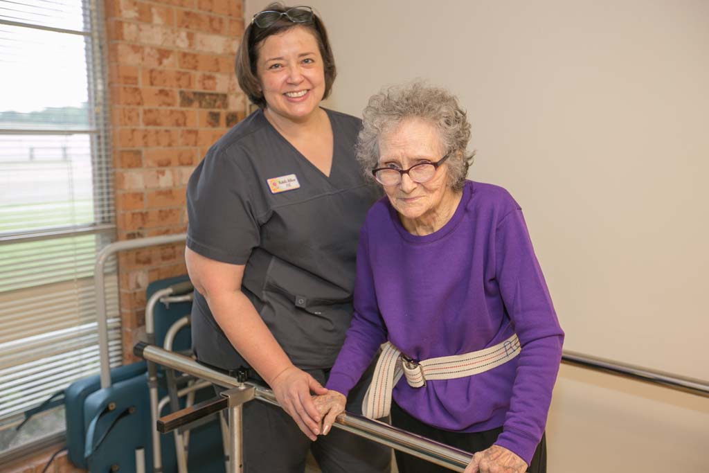 Smiling staff member assisting a resident