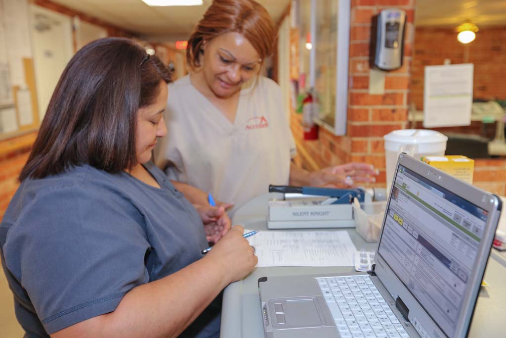 Two staff members collaborating at a desk