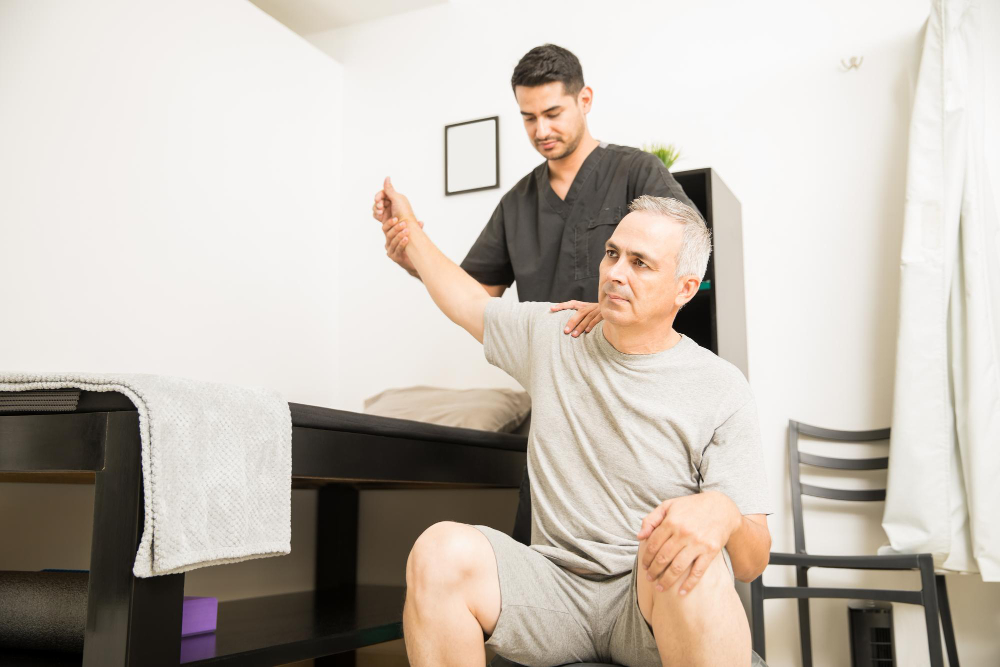 Therapist assisting a senior resident with exercise.