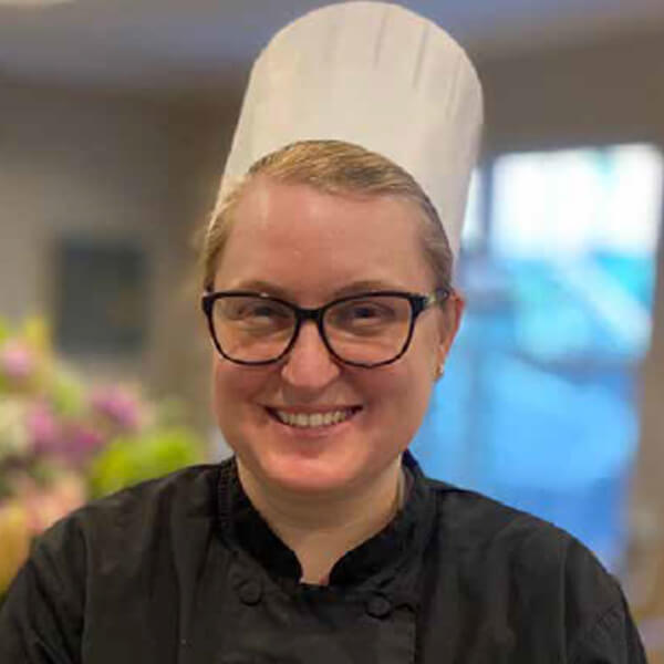 Smiling chef in a kitchen setting