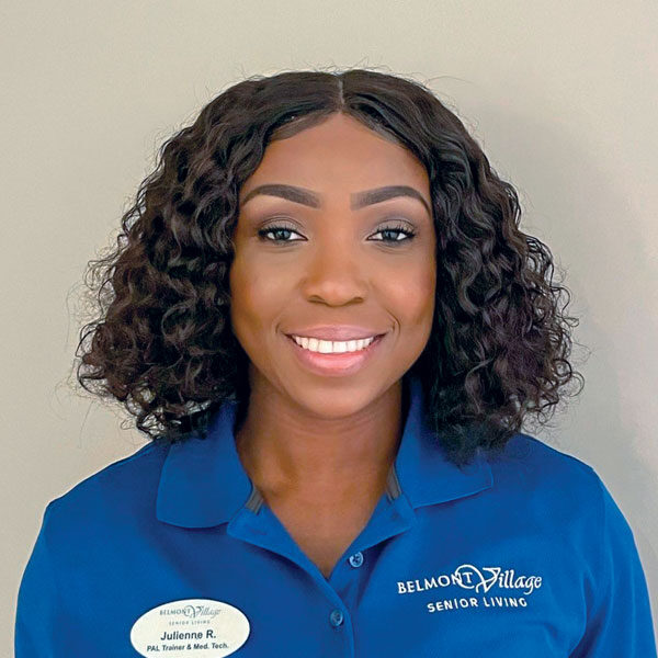 Staff member in a Belmont Village polo shirt