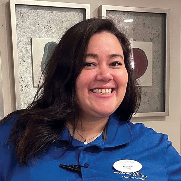 Staff member smiling in the facility's lobby area
