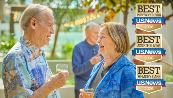 Residents enjoying drinks and conversation in a garden setting