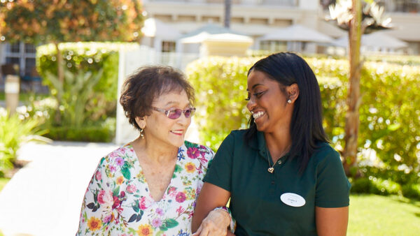 A resident and staff member enjoying a moment outdoors