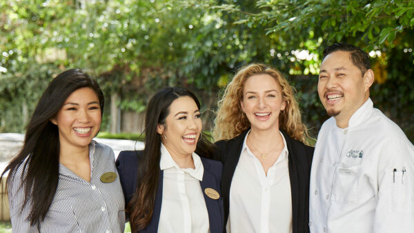 Staff members laughing in an outdoor setting