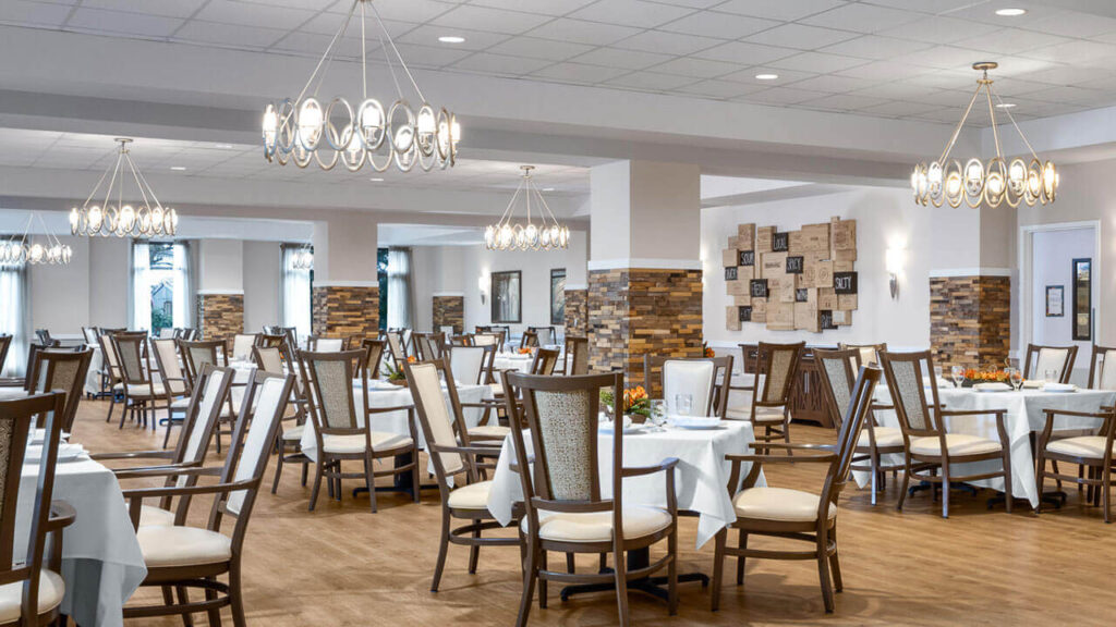 Dining area with tables and chairs set for meals