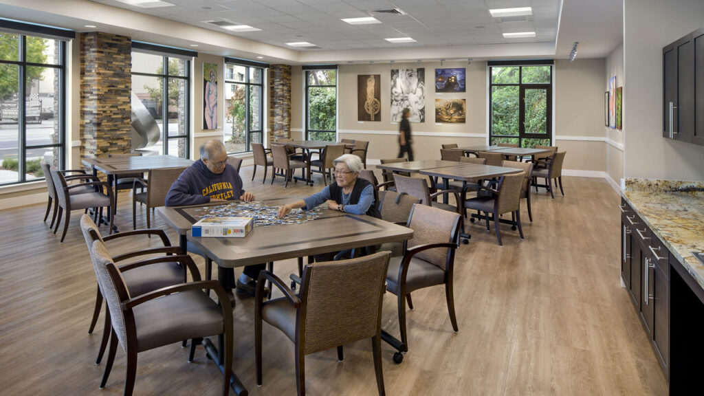 Residents enjoying a puzzle in a dining area