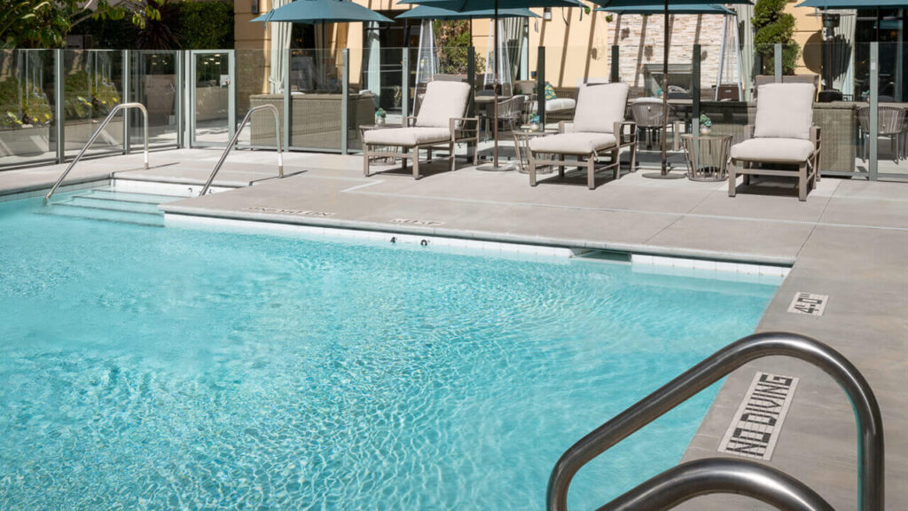 Outdoor swimming pool area with lounge chairs