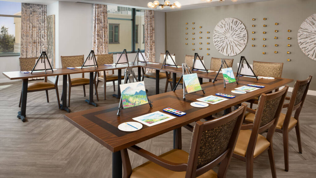 Art studio with easels and painting supplies for residents