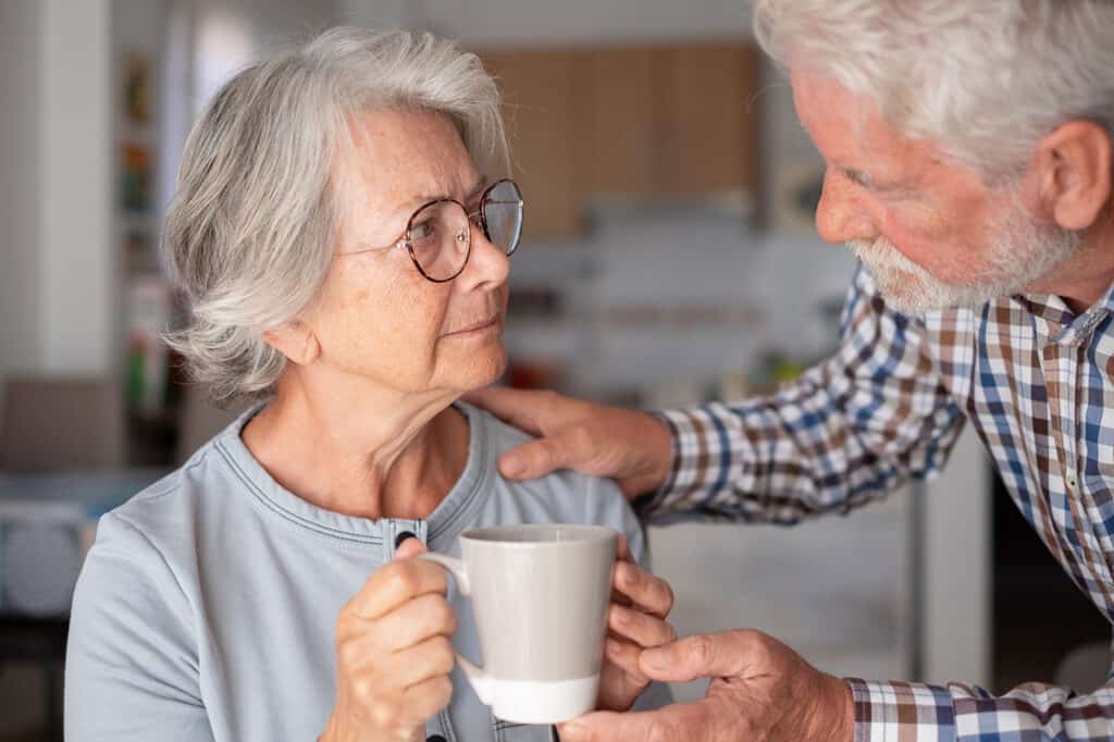 A senior woman and man sharing a moment over coffee