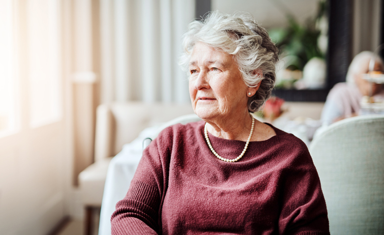 Portrait of a thoughtful elderly woman in a cozy interior