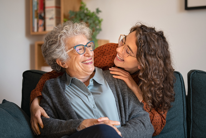 Residents smiling together in a cozy living room