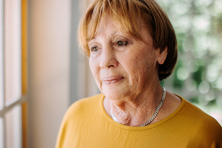 Portrait of an elderly woman smiling indoors