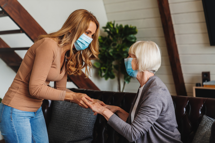 Staff member engaging with a resident in a cozy lounge