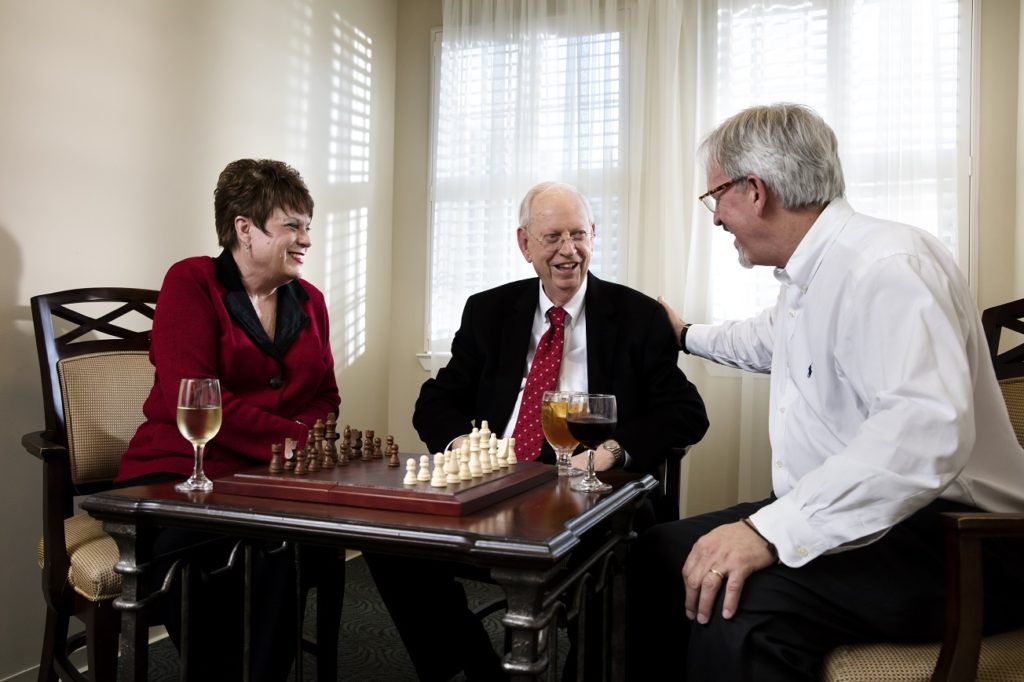 Residents enjoying a game of chess in a common area