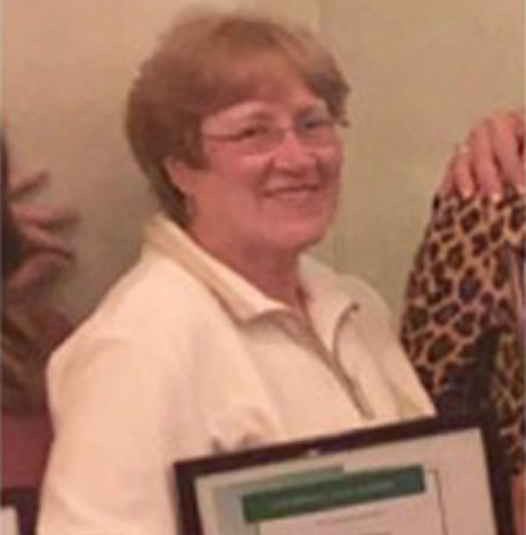 Resident celebrating with an award in a common area