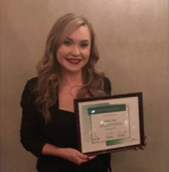 Woman holding an award certificate