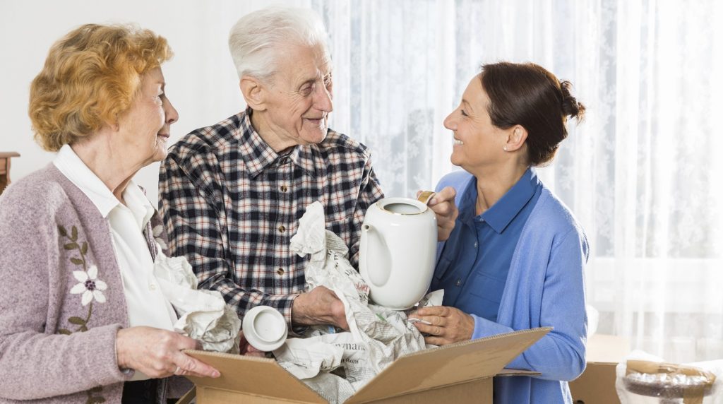 Residents packing items with staff assistance