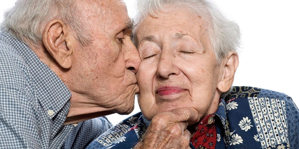 An elderly couple sharing a tender moment together