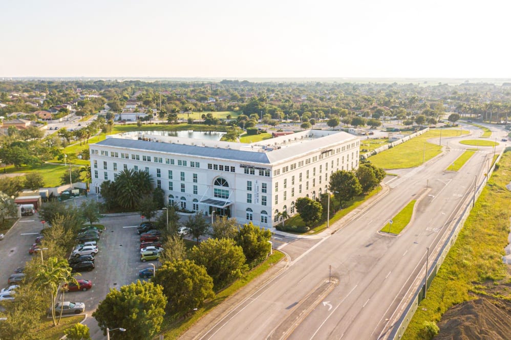 Aerial view of a senior living building and grounds