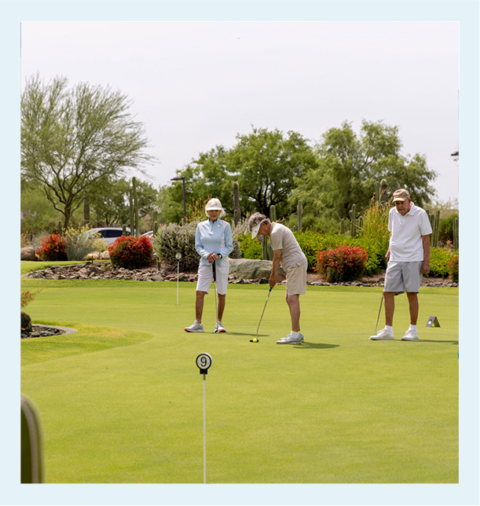 Residents playing golf in a landscaped outdoor area