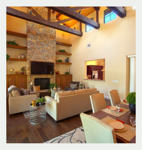 Bright common area with stone fireplace and seating