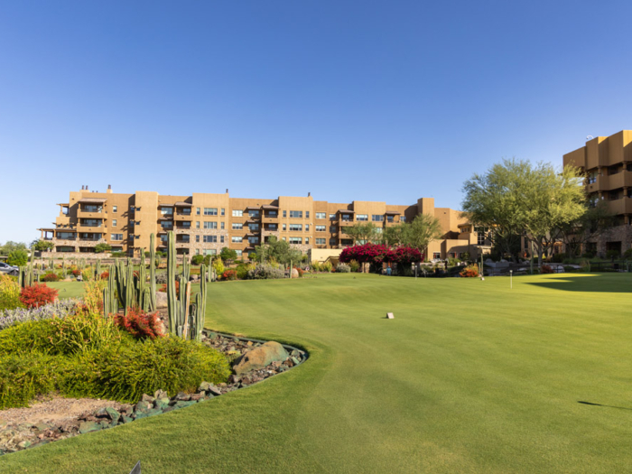 Outdoor area with lush landscaping and building in background