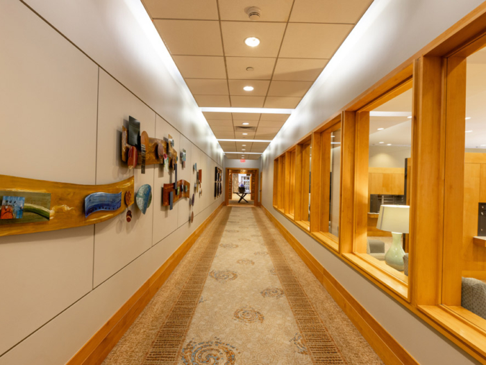 Brightly lit hallway with artwork on the walls