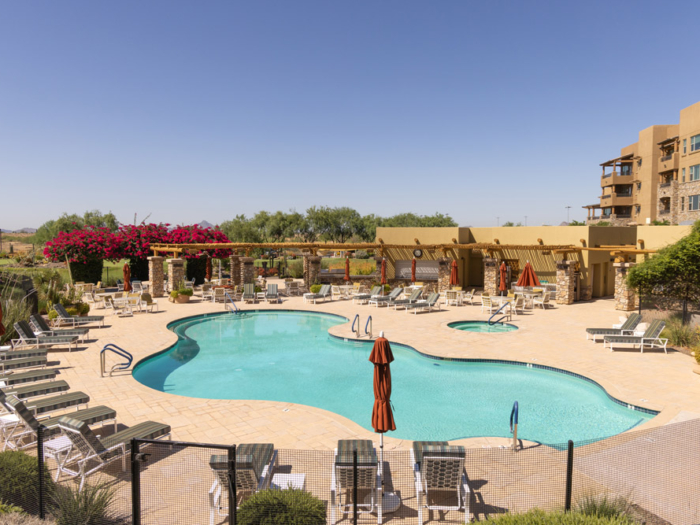 Pool area with lounge chairs and umbrellas