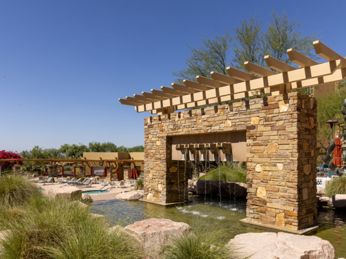 Beautiful outdoor space with a waterfall and desert landscaping