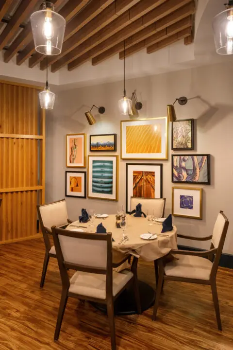 Dining area with elegant table setting and artwork