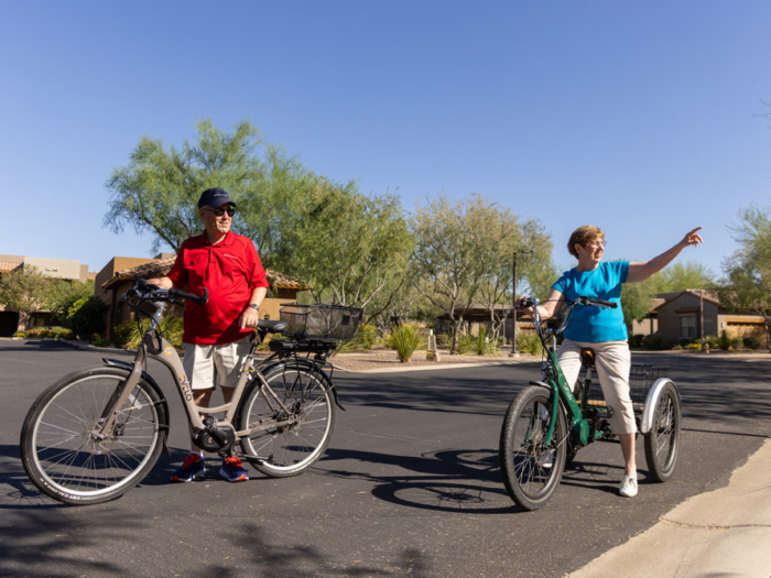 Two residents enjoying a bike ride outdoors