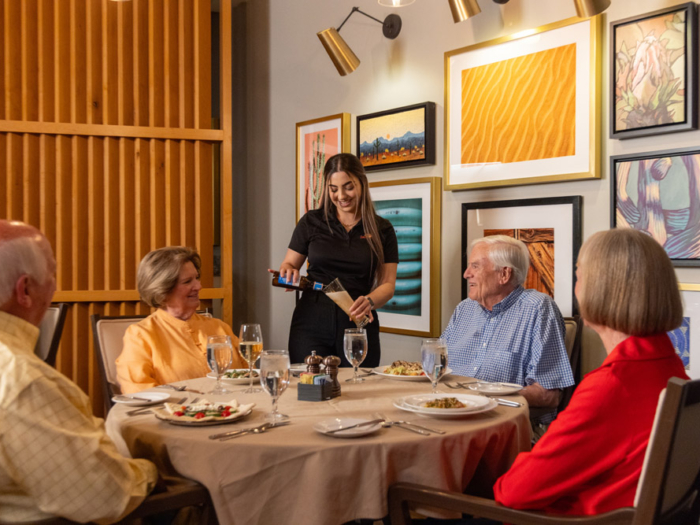 A group of residents enjoying a meal in the dining room