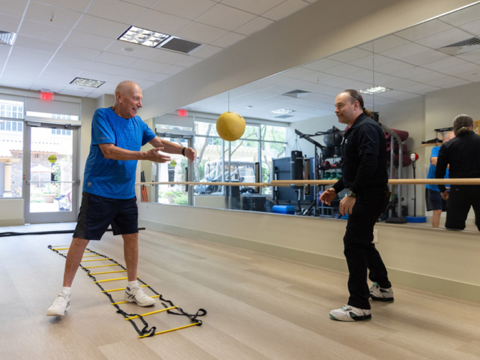 Residents participating in an exercise class in a fitness room