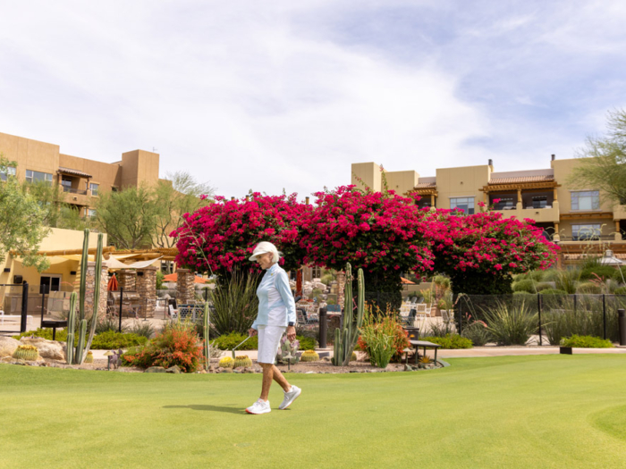Resident walking on green space with blooming plants