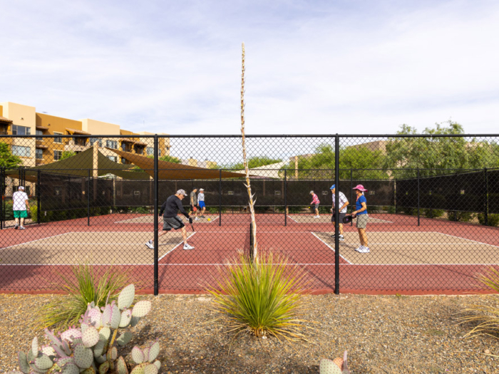 Residents playing pickleball in an outdoor court