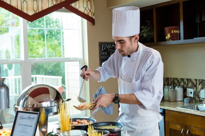 Chef preparing a meal in the dining area