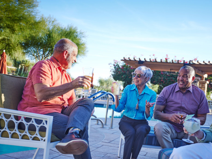 Residents enjoying drinks by the pool