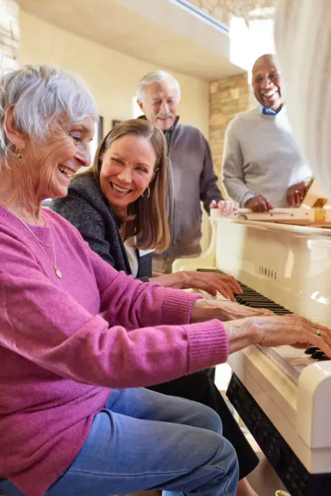 Residents joyfully playing piano together