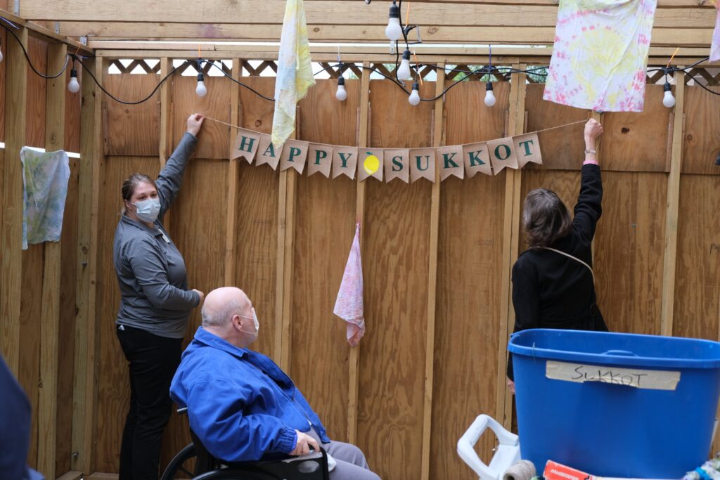 Residents and staff decorating for Sukkot celebration