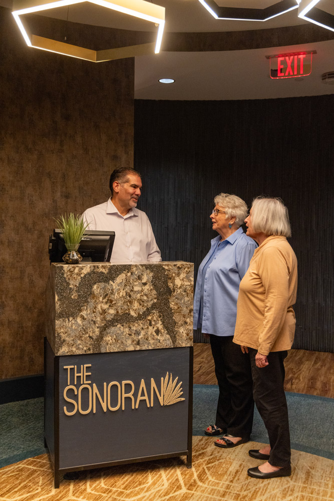 Staff assisting residents at the reception area