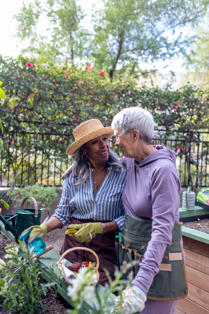 Two residents gardening in a vibrant outdoor space