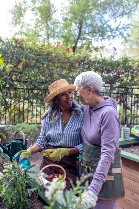 Two residents gardening together in the outdoors