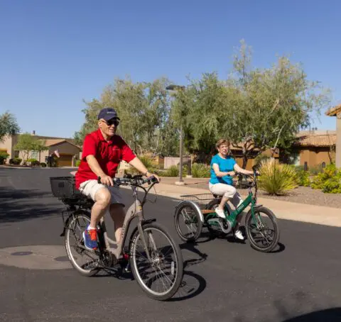 Residents biking on a sunny path outside