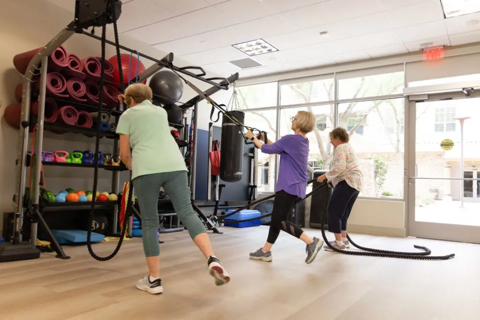 Residents participating in fitness activity in the facility's gym