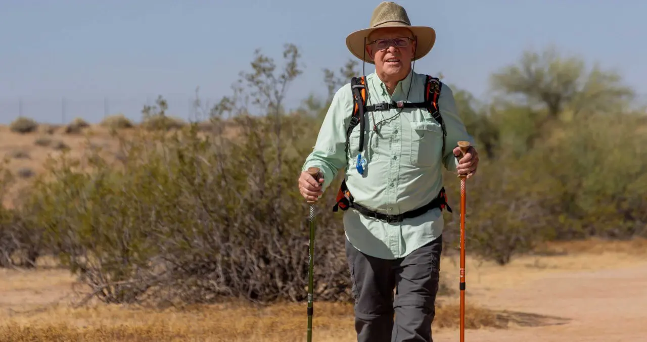 Senior man hiking outdoors in a desert landscape