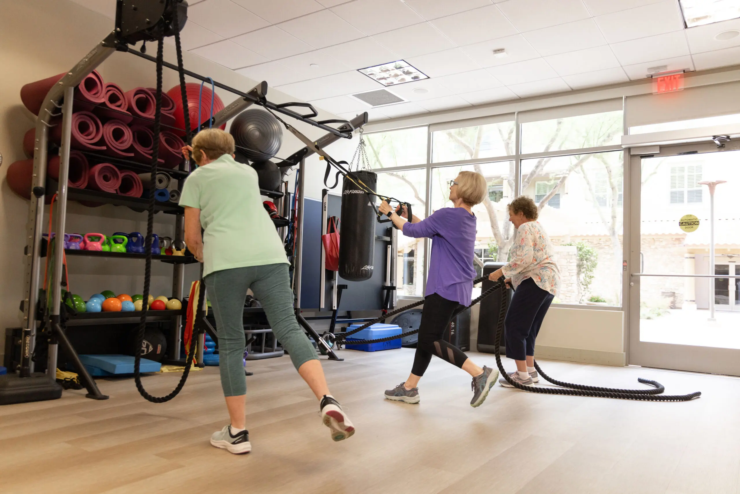 Residents engaged in a fitness activity in an exercise room