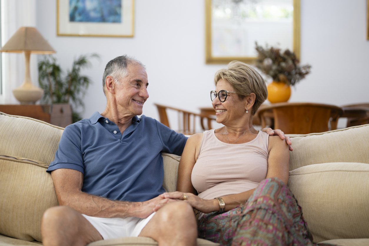 Senior couple enjoying a candid moment on a sofa