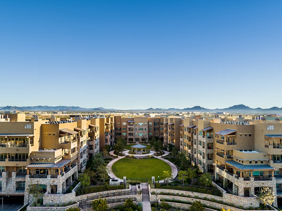 Aerial view of a senior living community with landscaped gardens